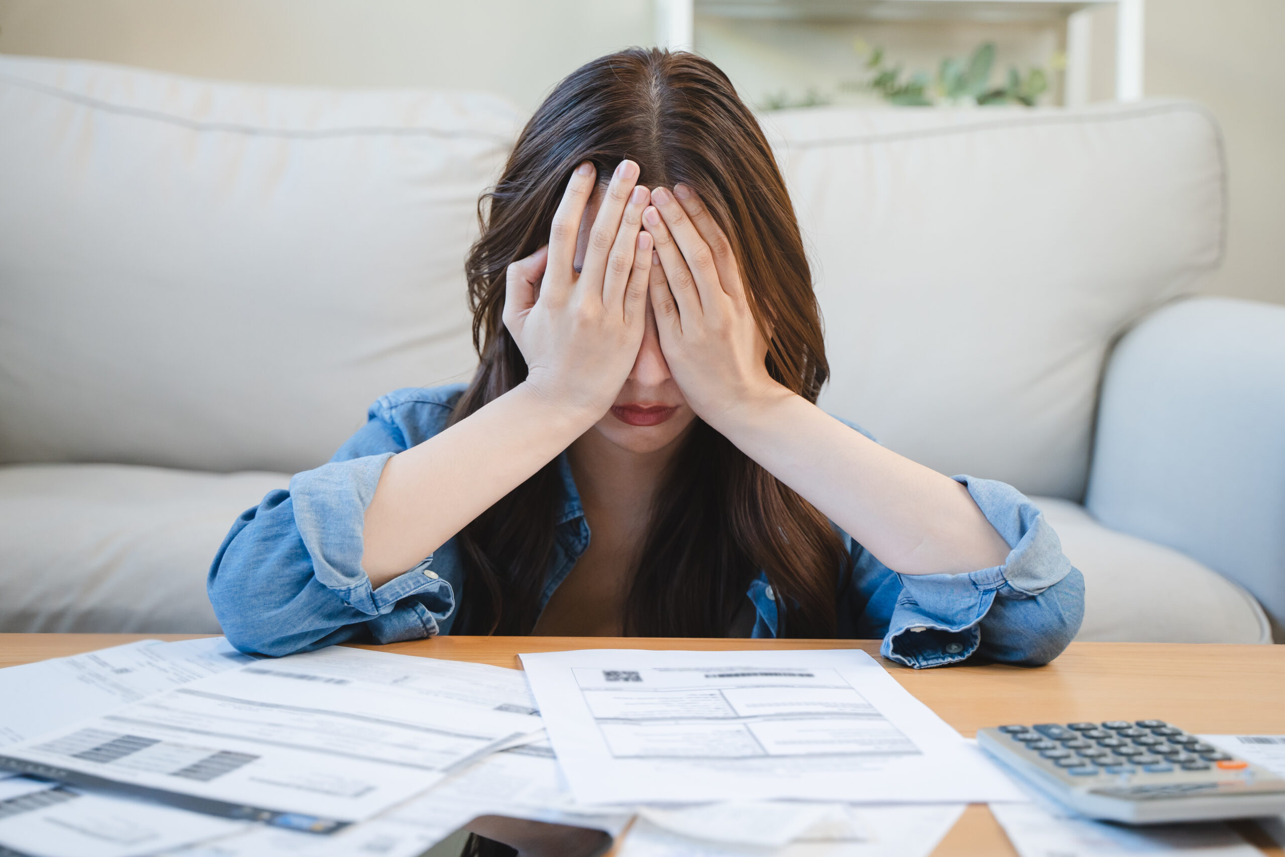 young woman cover her head after stressed with monthly bill