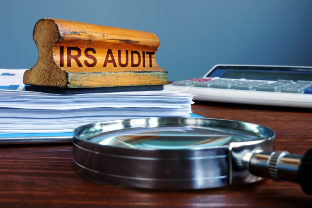 Stamp IRS audit and accounting documents.