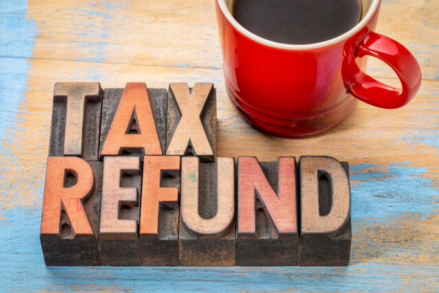 tax refund - word abstract in vintage letterpress wood type blocks with a cup of coffee